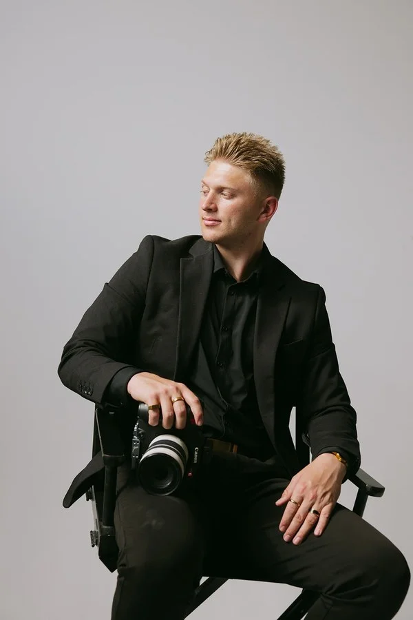 Dylan Simpson, seated in a director's chair with his cinema camera